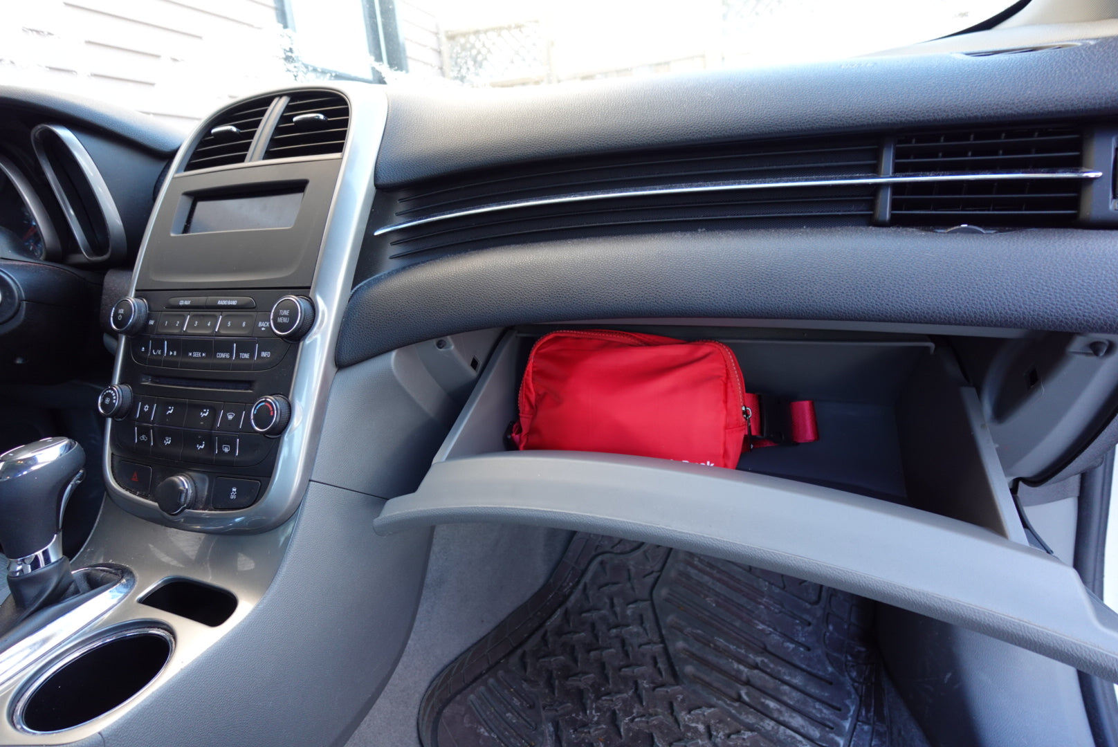 Red bag inside a car's dashboard compartment